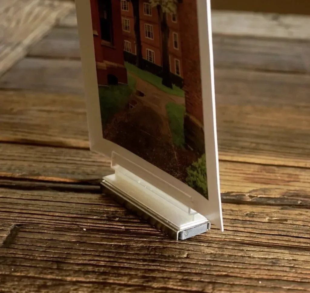 Retail display plastic extrusion used in a spring merchandising setup to support signage, shelving, and illuminated in-store displays